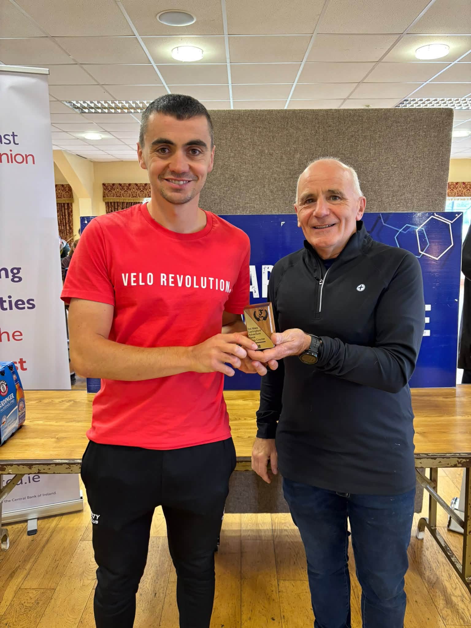 Prize giving: a winner in a red Velo Revolution t-shirt is presented with a trophy